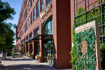Shoppers browsing local vendors and artisan goods at The Shops at Harvest Lofts, Dallas Farmers Market