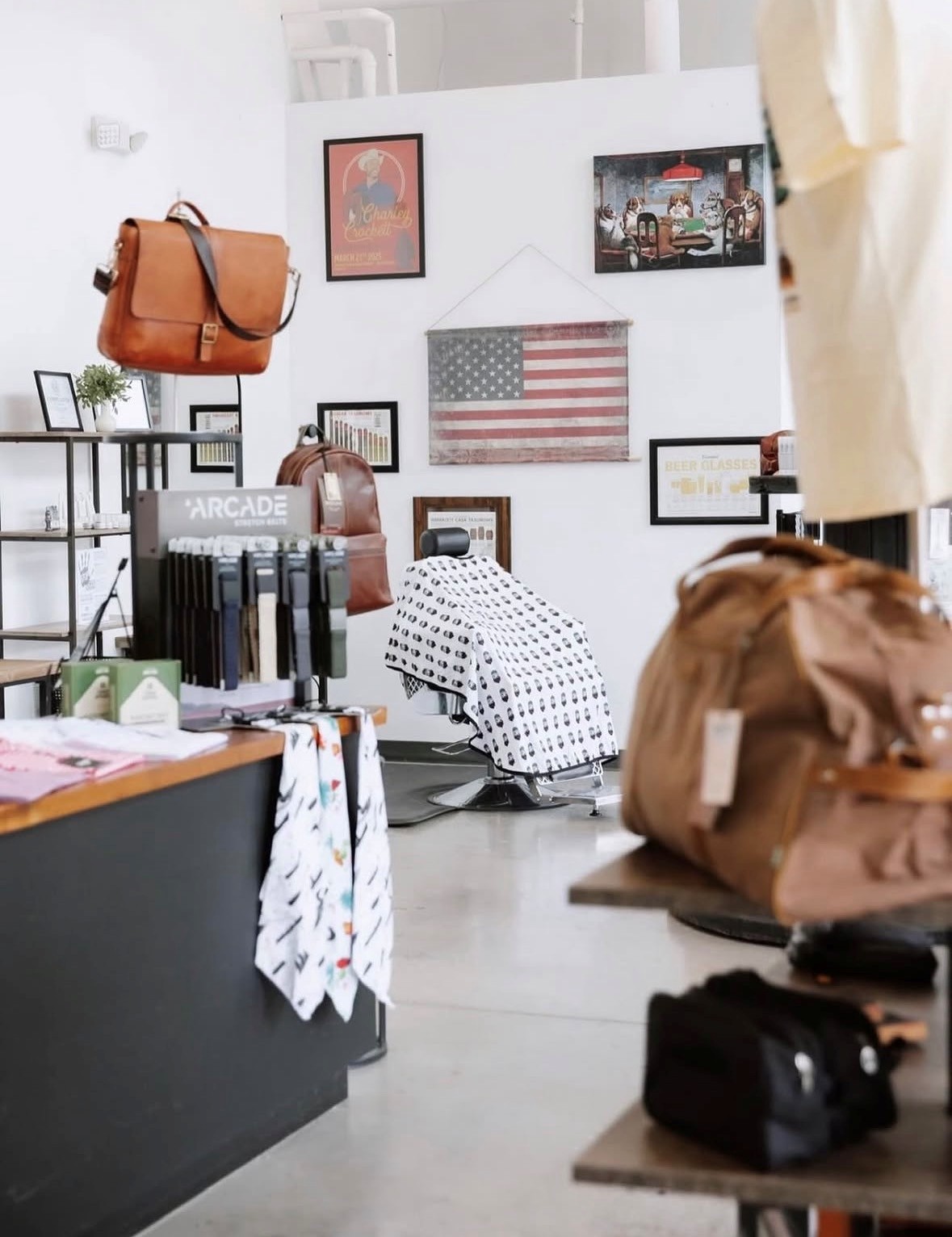 Interior of Big Daddy Beard — leather goods, barber chair, and curated accessories at Harvest Lofts